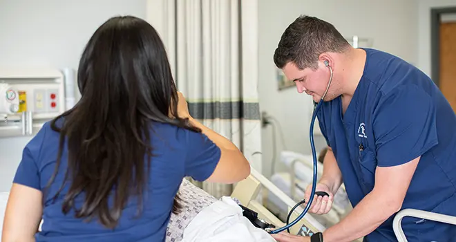 TCC Nursing Students working on a mannequin